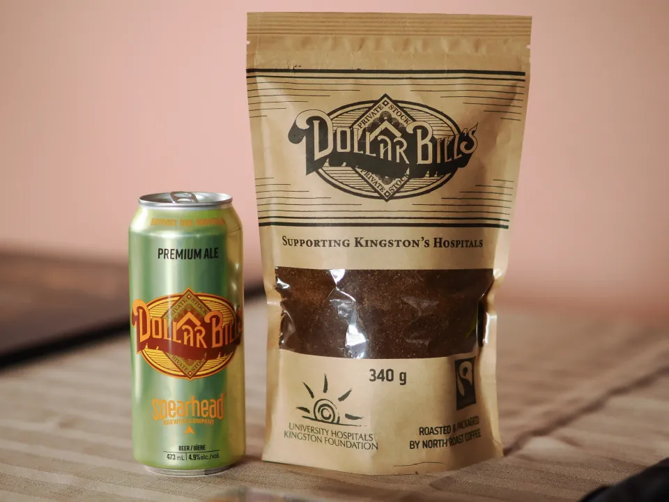 Dollar Bills coffee bag and Dollar Bills beer can on display.